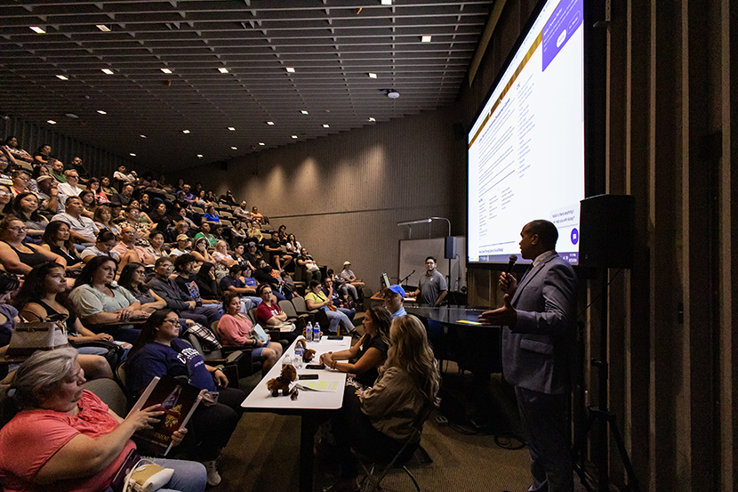 A group of students listening to a presentation