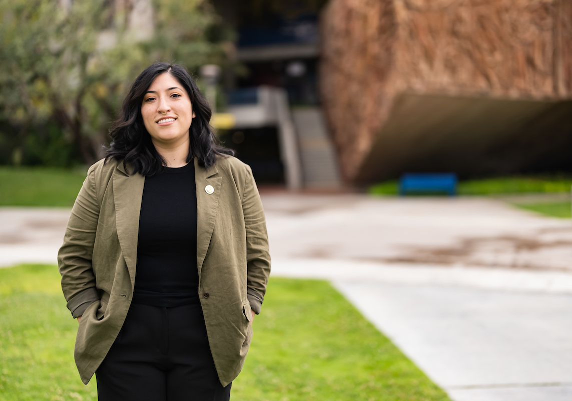 Amanda Macias poses in Gateway Plaza in front of the O'Cadiz concrete mural.