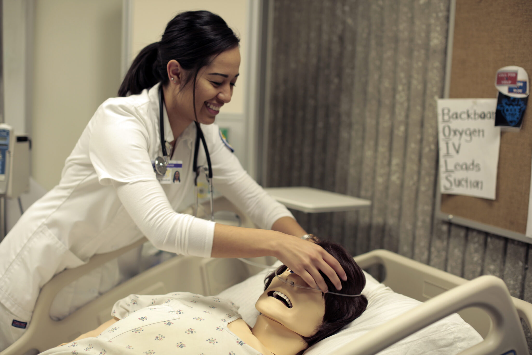 A nursing student practices in a lab.