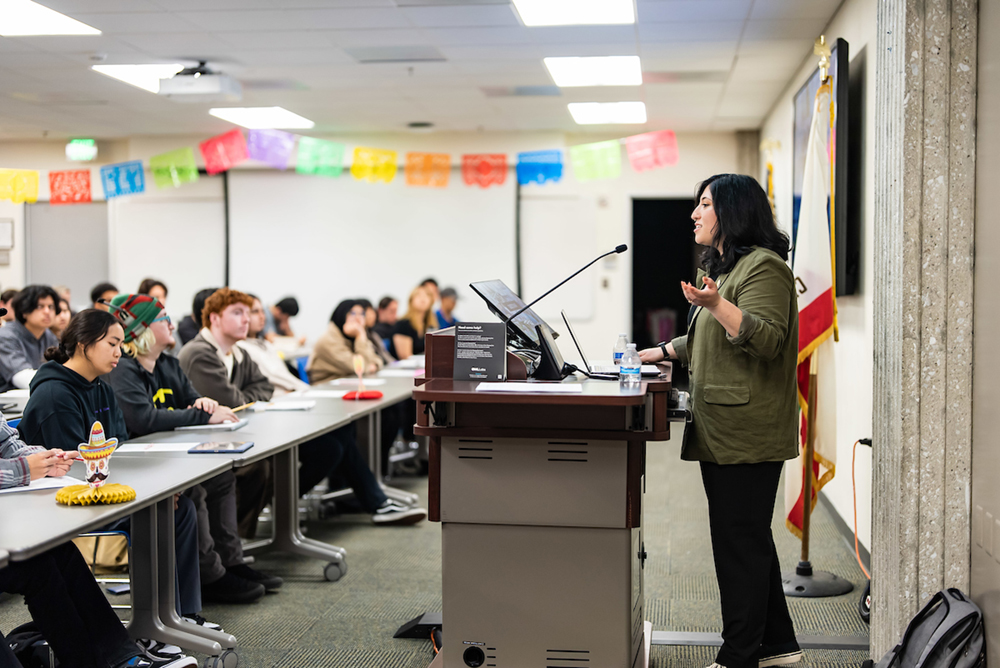 Amanda Macias addresses a roomful of STEM scholars at a Latinos in STEM event.